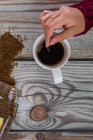 Woman hands with coffee cup, on wooden table. top view.の写真素材