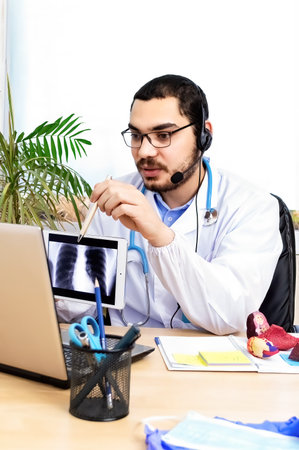 Doctor working from clinic on a video call.の写真素材