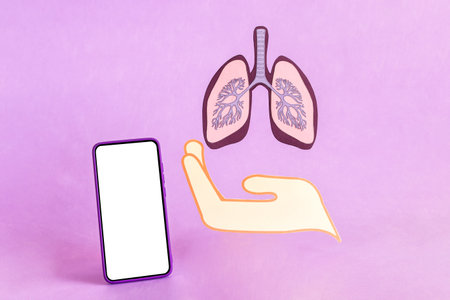 Hand show lungs figure and smart phone with blank screen.の写真素材