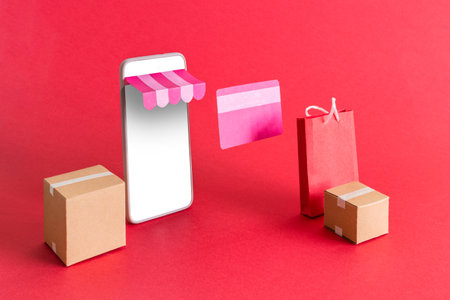 The concept of online shopping. Smart phone with shopping bag, delivery, boxes, and credit card. Promotion of digital stores.の写真素材