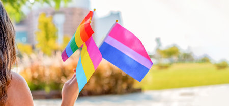 Genderqueer. People wave LGBTQ gay pride rainbow flags at a pride event. Select focus.の写真素材