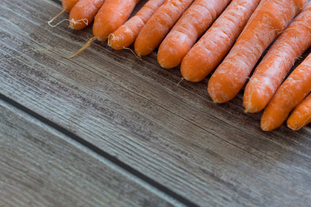 Freshly washed whole carrots on wooden table in Garden. Vegetables Vitamins Keratin. Natural Organic...