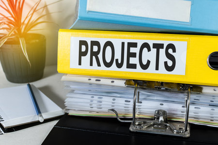 Office folder with inscription (text: PROJECTS) and Office Supplies, on desk. Business concept.の写真素材