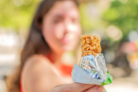 Close up female hand holding snack bar.の写真素材