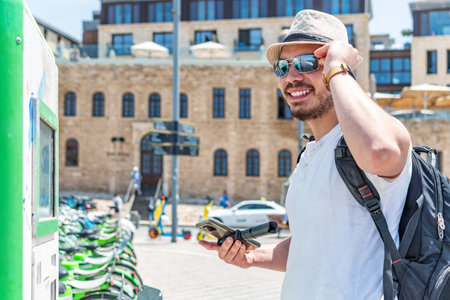 Young tourist next to urban bicycle rentals.の写真素材