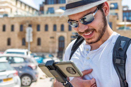 Young tourist checking mobile phone in tourist area.の写真素材