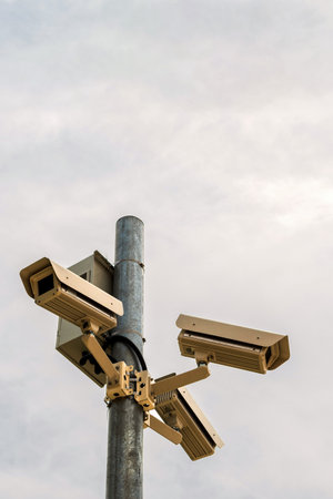 Three surveillance cameras on sky background. CCTV Security Cameras.の写真素材