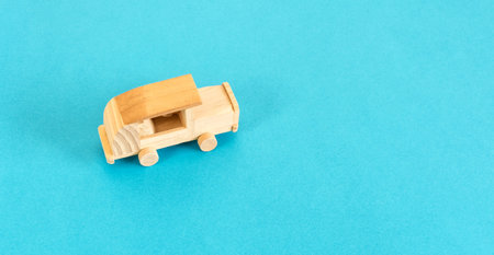 Wooden car toy isolated on blue background, top view.の写真素材