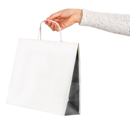 Female hand holding white shopping bag.の写真素材