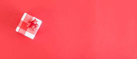 Top view of a small gift on red background.の写真素材