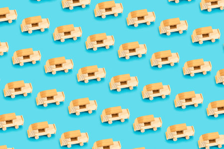 Wooden car toy pattern on pastel blue background.の写真素材
