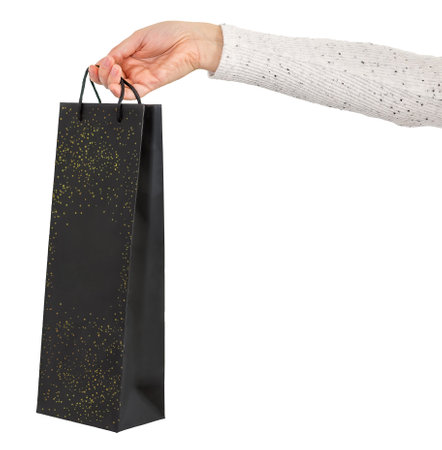 Female hand holding black shopping bag.の写真素材