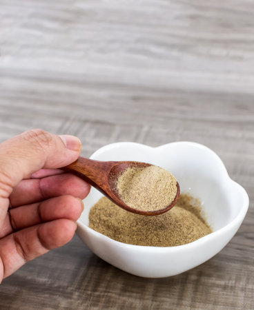 Close up of wooden spoon with white pepper.の写真素材