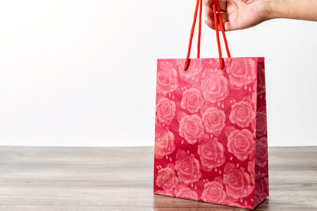 Shopping paper bags on a wooden table.の写真素材