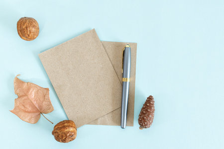 Blank paper sheet card with mockup copy space and dry leaf. Minimal and rustic invitation template.