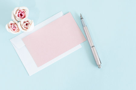 Blank greeting card with pink rose flowers. Mock up.の写真素材