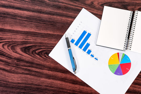 Statistical reports on wooden table.の写真素材