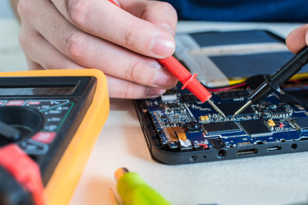 close up image of smart phone and tablet repair, in technology lab.の写真素材