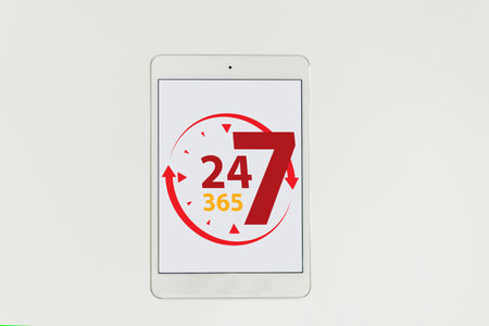 showing the tablet. Adaptive design screen. on wooden table. 24-hour service concept. technological concept. Isolated.の写真素材