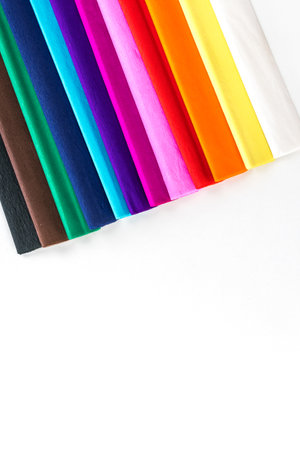 Crepe paper of various colors, forming a rainbow. on white background top viewの写真素材