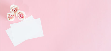 Blank white greeting card with pink rose flowers. Mock up.