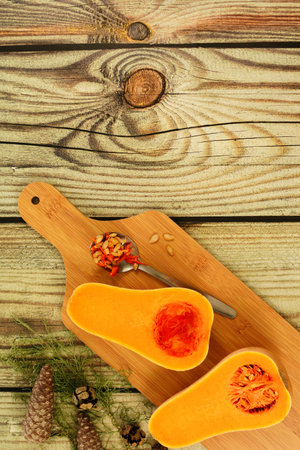 beautiful colorful autumn pine cone and pumpkin on wooden background. copy space text.の写真素材