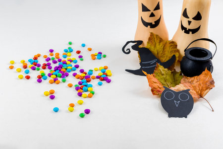 Halloween, pumpkins, owl silhouettes, colored sprinkles, cauldron, witch hat, on white background. Select focus.の写真素材