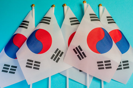 Group of Korean flags on light blue background. Still life.の写真素材