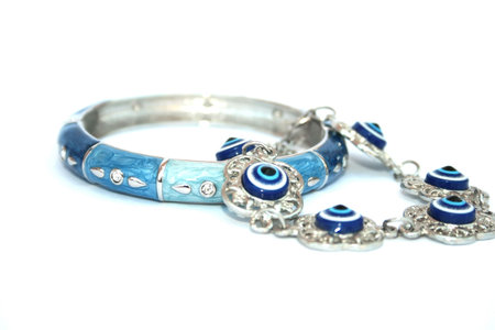 Metallic bracelet talisman with blue eyes and blue and cyan bracelet with silvery drops.
