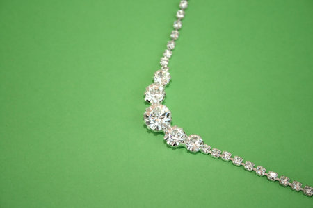 Beautiful necklace with stones isolated on the green.の写真素材