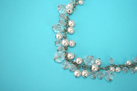 Beautiful necklace with perls isolated on the blue.の写真素材