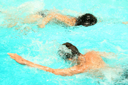 The girl and the boy in the swimming pool.の写真素材