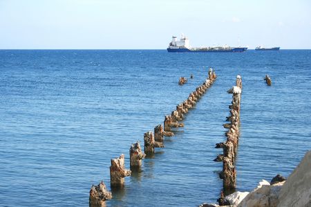 Old broken pier waits the ship.の写真素材