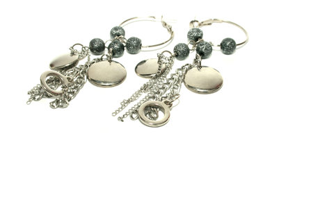 Silver earrings on white background.