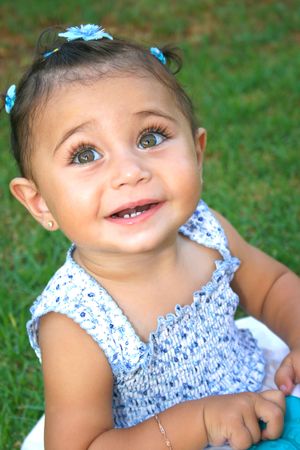 Little brunette smiling girl with bracelet.の写真素材