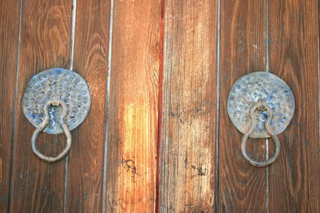 Vintage wooden door with metallic handles.の写真素材