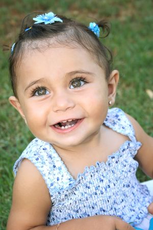 Little smiling girl in blue dress.の写真素材
