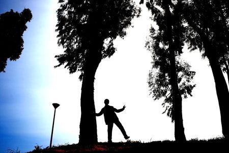 Silhouette of boy,trees and lamp.の写真素材