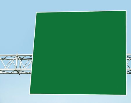 Empty green billboard on blue sky background.の写真素材