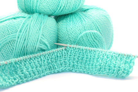Yarn and kniiting isolated on white background.