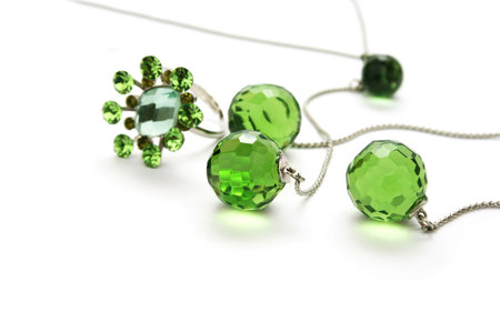 Necklace and ring with green transparent gemstones isolated on white background.の写真素材