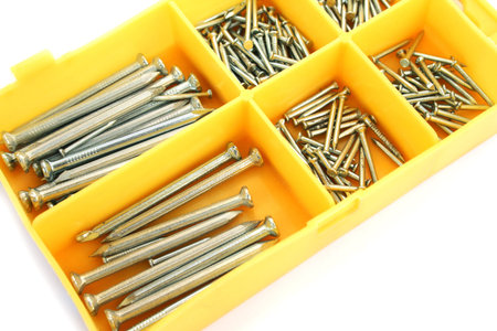 Nails in yellow box isolated on white background.の写真素材