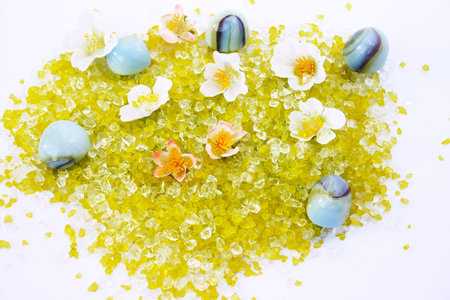 Colorful stones and flowers on gray background.の写真素材