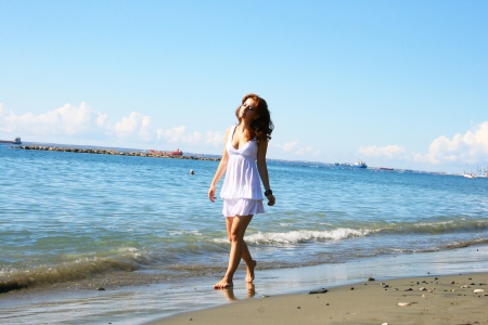 Pretty woman in white dress on beach in Limassol, Cyprus.の写真素材