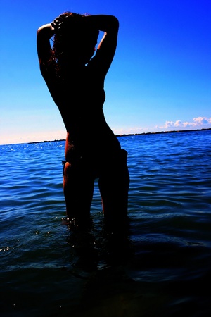 Silhouette of woman in the sea の写真素材