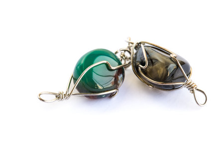 Earrings with natural colorful stones isolated on white background.