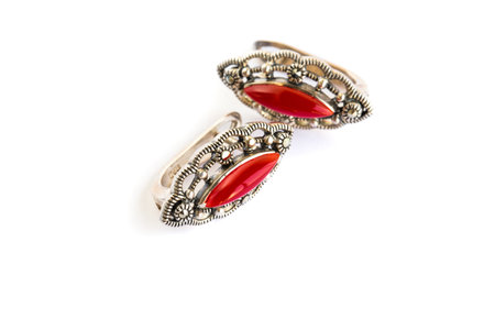 Earrings with red stones isolated on white background.の写真素材