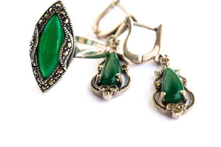 Earrings and ring with natural green stones isolated on white background.の写真素材