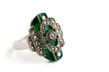 Silver ring with green stone isolated on white background.の写真素材