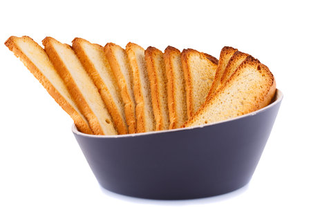 Rusks in blue bowl isolated on white background.の写真素材